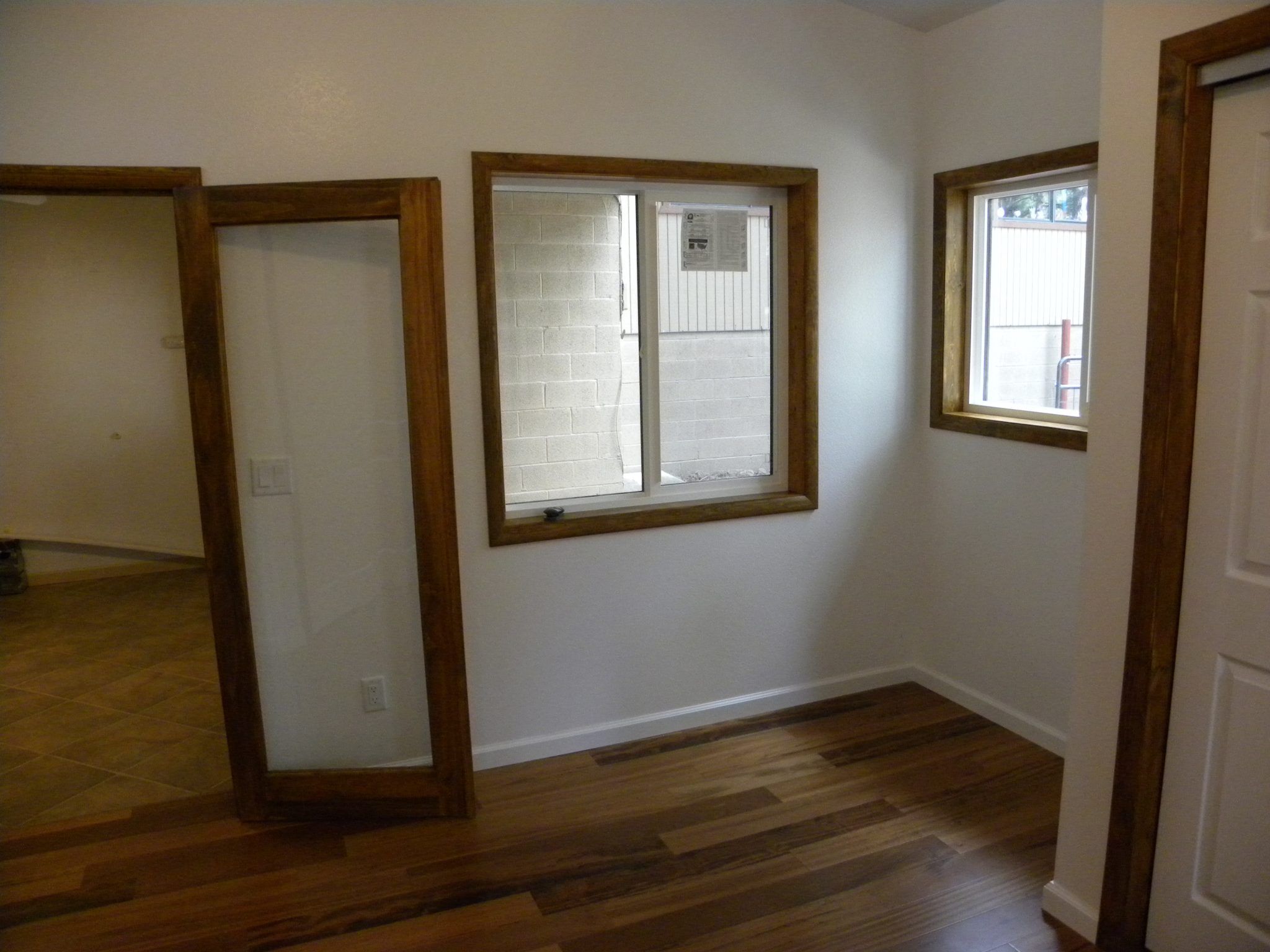 Interior shot of wood trimmed windows and doorways with new wooden flooring
