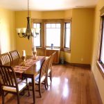 A newly remodeled dining room with wood trimmed windows and new flooring