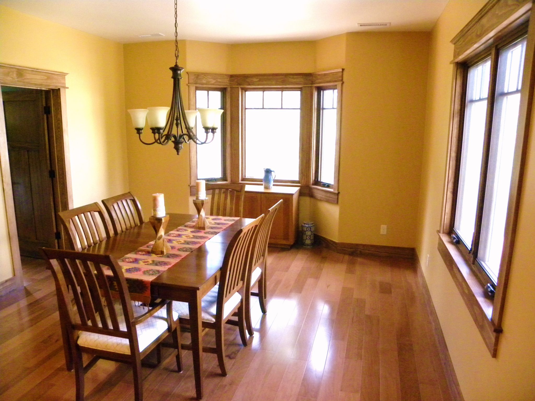 A newly remodeled dining room with wood trimmed windows and new flooring